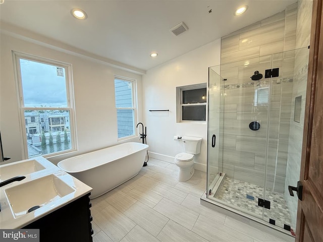 40 Bryant St NW, Washington, DC 20001 - bathroom with vanity, a stall shower, a freestanding tub, toilet, and baseboards