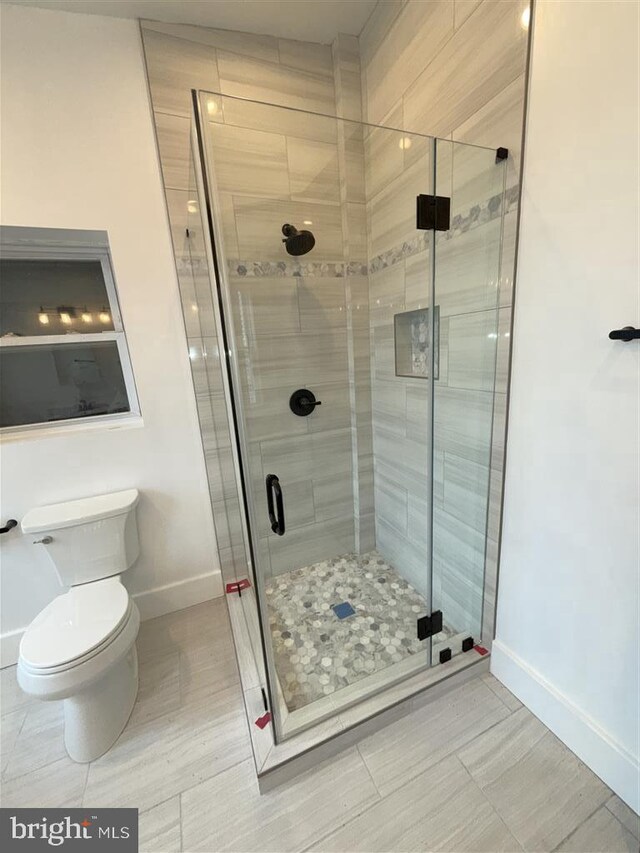 40 Bryant St NW, Washington, DC 20001 - bathroom featuring baseboards, a shower stall, and toilet