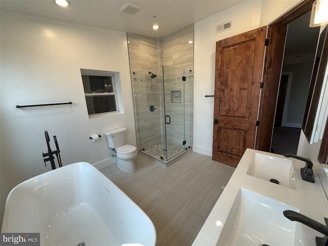 40 Bryant St NW, Washington, DC 20001 - bathroom featuring a freestanding bath, a stall shower, double vanity, baseboards, and toilet