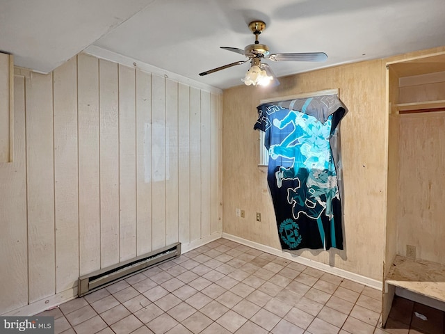 178 Fulton Ave, Charles Town, WV 25414 - unfurnished room with a baseboard radiator, wooden walls, a ceiling fan, and tile patterned floors