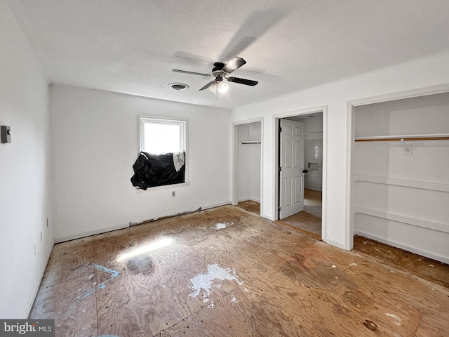 178 Fulton Ave, Charles Town, WV 25414 - unfurnished bedroom with two closets, a textured ceiling, and a ceiling fan