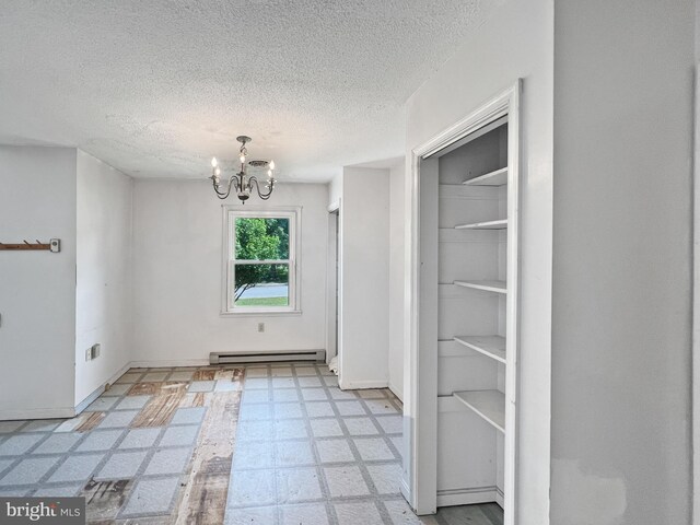 178 Fulton Ave, Charles Town, WV 25414 - unfurnished dining area featuring baseboard heating, a chandelier, light flooring, a textured ceiling, and baseboards