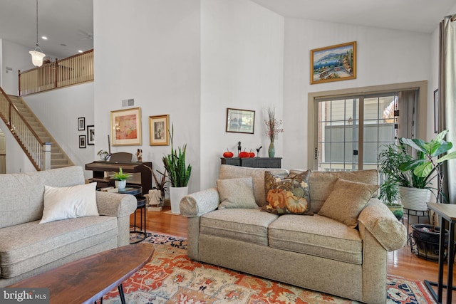 66 Farmview Ln, Lititz, PA 17543 - living room with high vaulted ceiling, wood finished floors, stairway, and recessed lighting