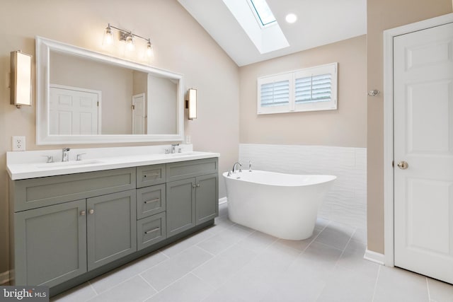 285 Cherry Ln, Kennett Square, PA 19348 - full bath featuring a skylight, lofted ceiling, double vanity, a freestanding tub, and tile patterned floors