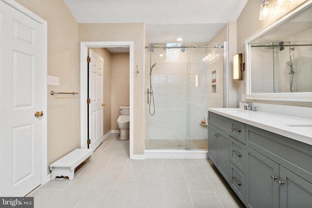 285 Cherry Ln, Kennett Square, PA 19348 - bathroom featuring tile patterned flooring, toilet, a shower stall, double vanity, and baseboards