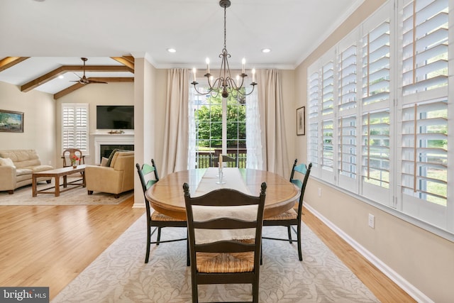 285 Cherry Ln, Kennett Square, PA 19348 - dining space with light wood-style flooring, plenty of natural light, a fireplace, a chandelier, and ornamental molding
