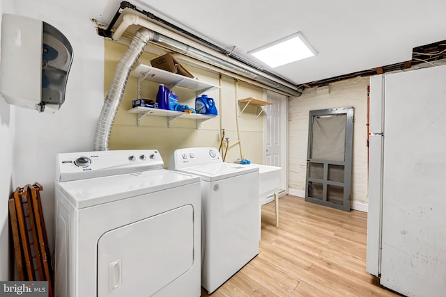 434 Elrino St, Baltimore, MD 21224 - laundry room with independent washer and dryer and light wood-style flooring
