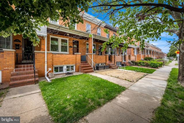 434 Elrino St, Baltimore, MD 21224 - view of front of home featuring brick siding and a front lawn