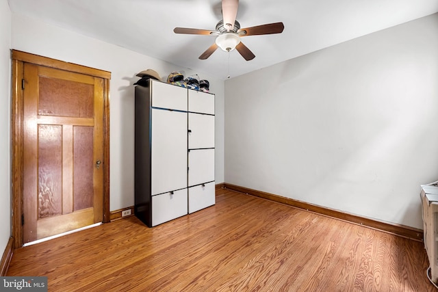 434 Elrino St, Baltimore, MD 21224 - unfurnished bedroom featuring light wood-type flooring, baseboards, and a ceiling fan