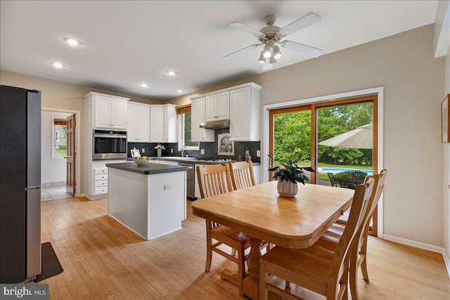 10 Evans Ln, Lawrenceville, NJ 08648 - kitchen featuring appliances with stainless steel finishes, a center island, backsplash, white cabinetry, and healthy amount of natural light