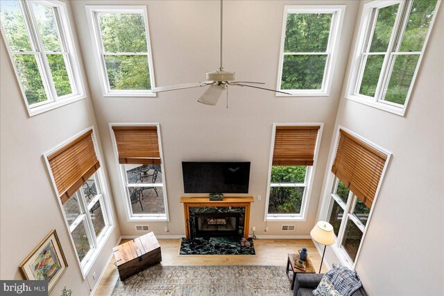 10 Evans Ln, Lawrenceville, NJ 08648 - living room with a high ceiling, a fireplace, ceiling fan, wood finished floors, and baseboards
