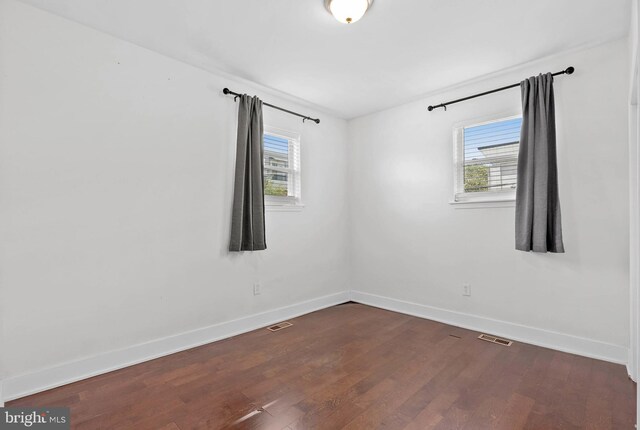 154 Mercy St, Philadelphia, PA 19148 - unfurnished room with baseboards, healthy amount of natural light, and dark wood-style flooring