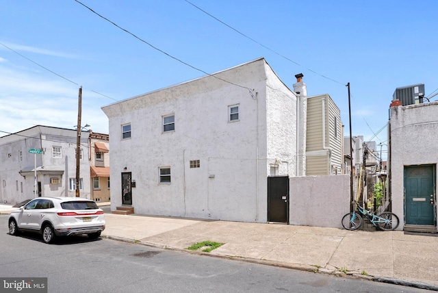 154 Mercy St, Philadelphia, PA 19148 - view of side of home with cooling unit and stucco siding