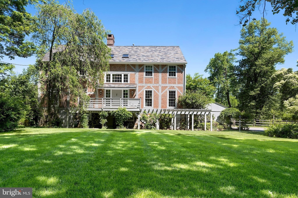 563 Cherry Valley Rd, Princeton, NJ 08540 - back of house with a chimney, a pergola, brick siding, and a high end roof