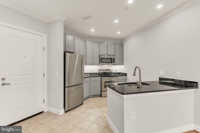 1391 Pennsylvania Ave SE Unit 348, Washington, DC 20003 - kitchen with stainless steel appliances, crown molding, dark countertops, a sink, and a peninsula