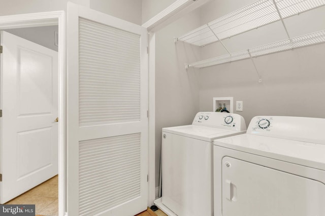 1391 Pennsylvania Ave SE Unit 348, Washington, DC 20003 - washroom with washer and clothes dryer and light tile patterned floors
