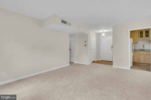 6517 Potomac Ave Unit A2, Alexandria, VA 22307 - unfurnished living room featuring light colored carpet, baseboards, and a sink