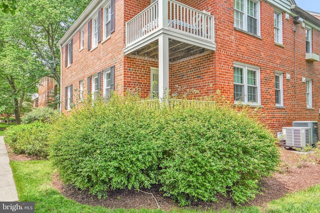 6517 Potomac Ave Unit A2, Alexandria, VA 22307 - view of property exterior with a balcony, brick siding, and central air condition unit