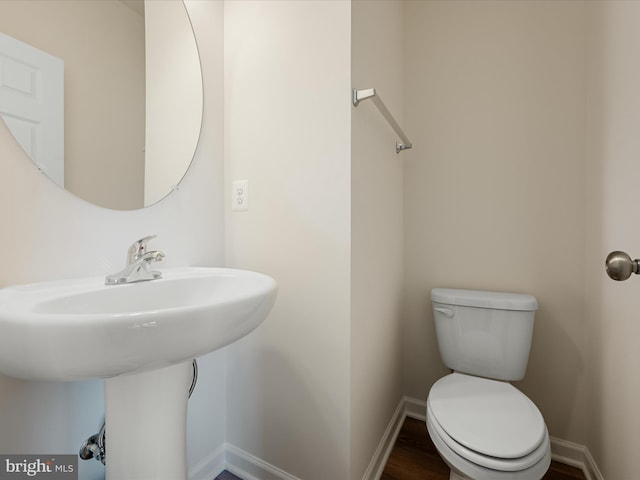 113 Heyford Dr, Stephenson, VA 22656 - bathroom featuring toilet, baseboards, a sink, and wood finished floors