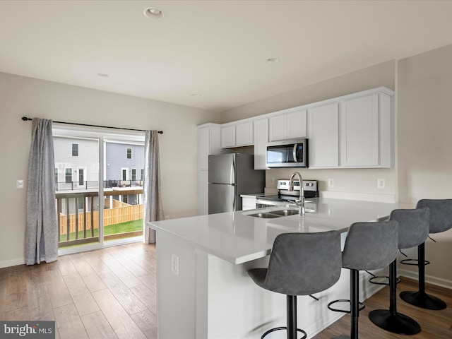 113 Heyford Dr, Stephenson, VA 22656 - kitchen featuring stainless steel appliances, a kitchen breakfast bar, and light wood finished floors