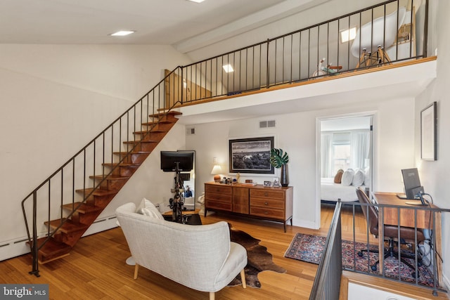 1011 Dickinson St, Philadelphia, PA 19147 - living room with high vaulted ceiling, stairway, and wood finished floors