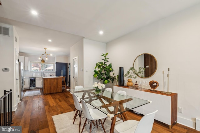 1011 Dickinson St, Philadelphia, PA 19147 - dining space featuring beverage cooler, dark wood finished floors, a chandelier, recessed lighting, and baseboards