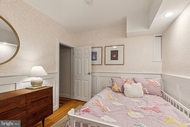 1011 Dickinson St, Philadelphia, PA 19147 - bedroom featuring wainscoting, wallpapered walls, and light wood-style flooring