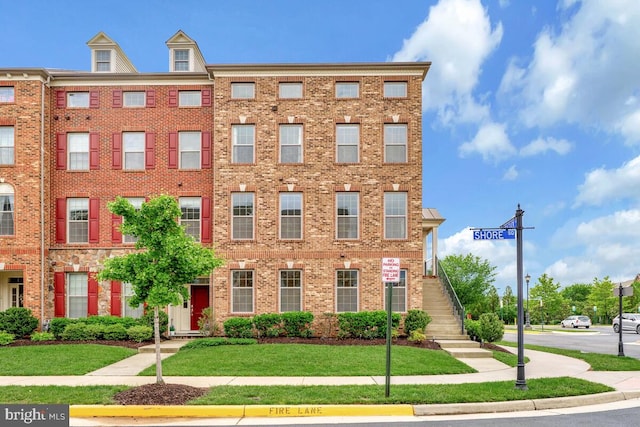 22635 Naugatuck Sq, Ashburn, VA 20148 - view of front facade featuring stairs, brick siding, and a front yard