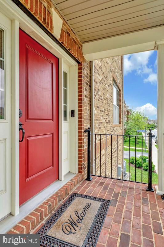 22635 Naugatuck Sq, Ashburn, VA 20148 - entrance to property featuring a porch and brick siding