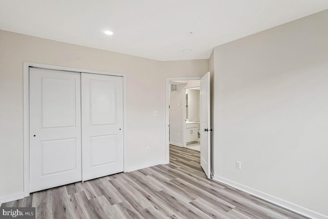 22635 Naugatuck Sq, Ashburn, VA 20148 - unfurnished bedroom with light wood-style flooring, a closet, baseboards, and recessed lighting