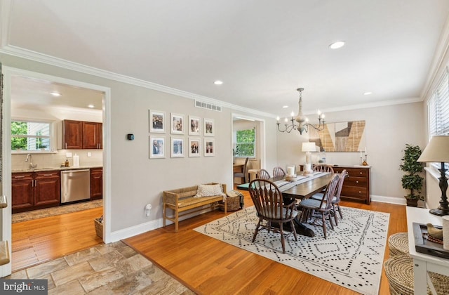 2218 Oakwood Ln, Atco, NJ 08004 - dining area with healthy amount of natural light, a chandelier, baseboards, ornamental molding, and recessed lighting