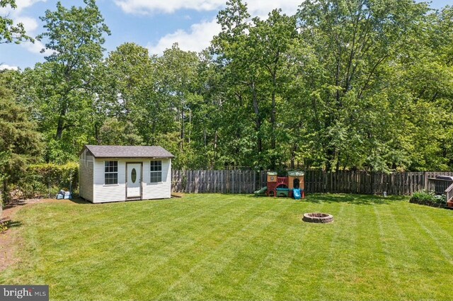 2218 Oakwood Ln, Atco, NJ 08004 - view of yard featuring a fire pit and an outdoor structure