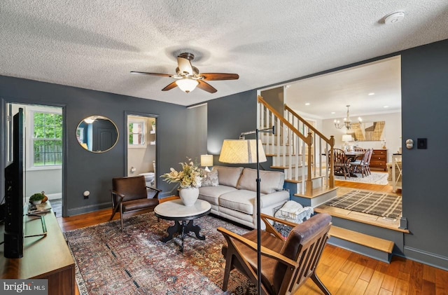 2218 Oakwood Ln, Atco, NJ 08004 - living area with stairs, a ceiling fan, baseboards, a chandelier, and a textured ceiling