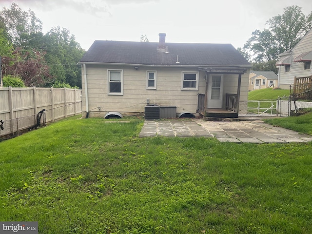 3403 Murdock Rd, Kensington, MD 20895 - back of house with a patio, a chimney, a gate, and central AC unit