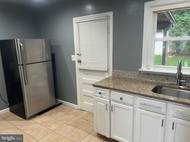 3403 Murdock Rd, Kensington, MD 20895 - kitchen with freestanding refrigerator, a sink, white cabinets, light tile patterned floors, and dark stone countertops