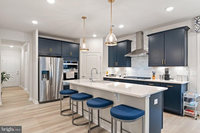 6411 Tulip Ter, Haymarket, VA 20169 - kitchen featuring appliances with stainless steel finishes, wall chimney range hood, a sink, a breakfast bar, and tasteful backsplash