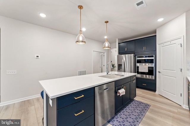 6411 Tulip Ter, Haymarket, VA 20169 - kitchen with a sink, stainless steel appliances, light wood-style floors, light countertops, and recessed lighting