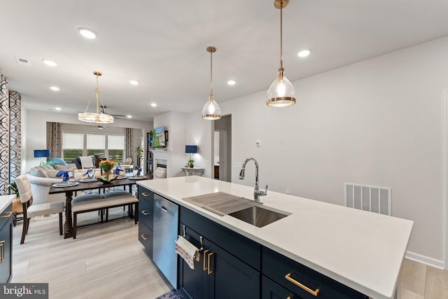 6411 Tulip Ter, Haymarket, VA 20169 - kitchen with a sink, open floor plan, dishwasher, light wood-type flooring, and light countertops