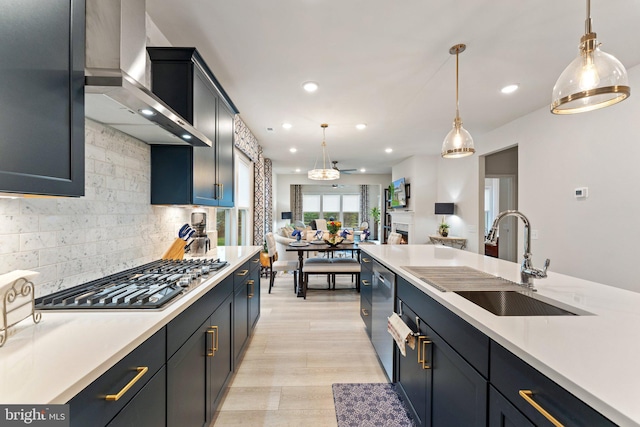 6411 Tulip Ter, Haymarket, VA 20169 - kitchen with wall chimney range hood, stainless steel appliances, light countertops, recessed lighting, and a sink