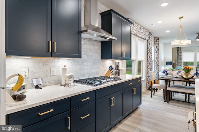 6411 Tulip Ter, Haymarket, VA 20169 - kitchen featuring wall chimney exhaust hood, stainless steel gas cooktop, tasteful backsplash, recessed lighting, and hanging light fixtures