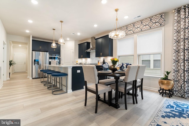 6411 Tulip Ter, Haymarket, VA 20169 - dining room featuring light wood-style flooring, baseboards, recessed lighting, and a chandelier