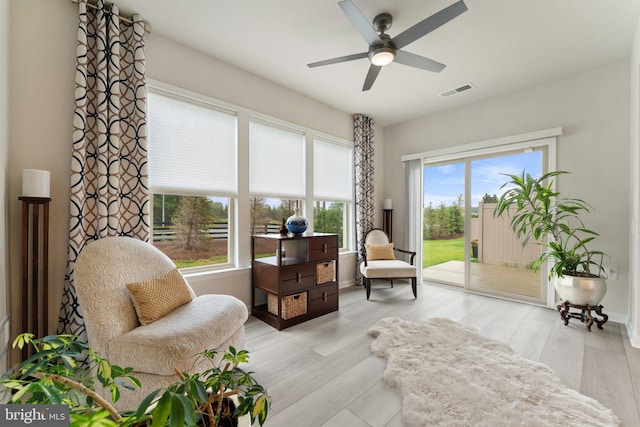 6411 Tulip Ter, Haymarket, VA 20169 - sitting room featuring healthy amount of natural light, a ceiling fan, light wood-style floors, and baseboards