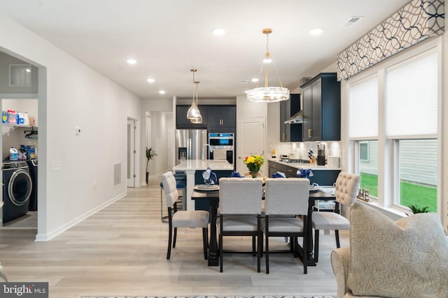 6411 Tulip Ter, Haymarket, VA 20169 - dining area featuring plenty of natural light, light wood-style floors, recessed lighting, a chandelier, and baseboards