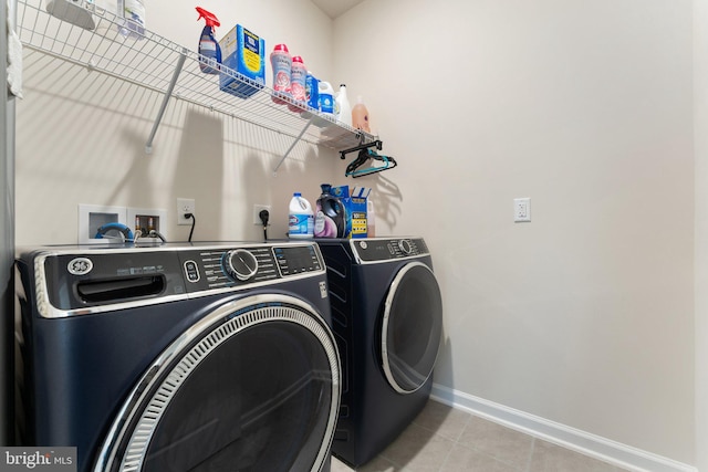 6411 Tulip Ter, Haymarket, VA 20169 - laundry room with washing machine and dryer, baseboards, and light tile patterned flooring