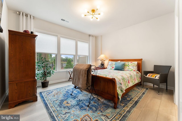 6411 Tulip Ter, Haymarket, VA 20169 - bedroom with a chandelier, light wood finished floors, and baseboards