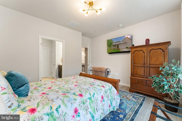 6411 Tulip Ter, Haymarket, VA 20169 - bedroom with light wood-style flooring, a chandelier, baseboards, and ensuite bath
