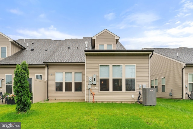 6411 Tulip Ter, Haymarket, VA 20169 - back of property featuring cooling unit, a yard, and roof with shingles