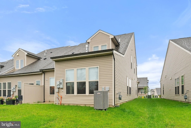 6411 Tulip Ter, Haymarket, VA 20169 - back of house with cooling unit, a yard, and a shingled roof
