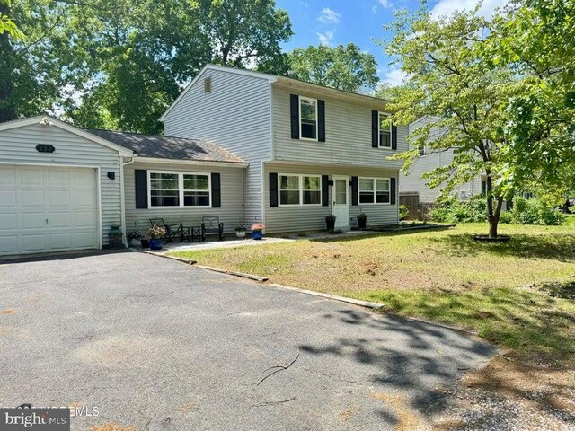 159 Harwich St, Browns Mills, NJ 08015 - colonial inspired home with a garage, a front lawn, and asphalt driveway
