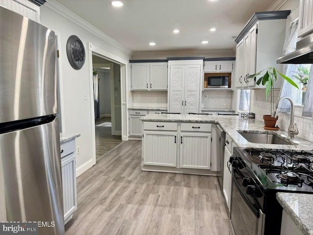 159 Harwich St, Browns Mills, NJ 08015 - kitchen with stainless steel appliances, a sink, light wood-style flooring, decorative backsplash, and crown molding